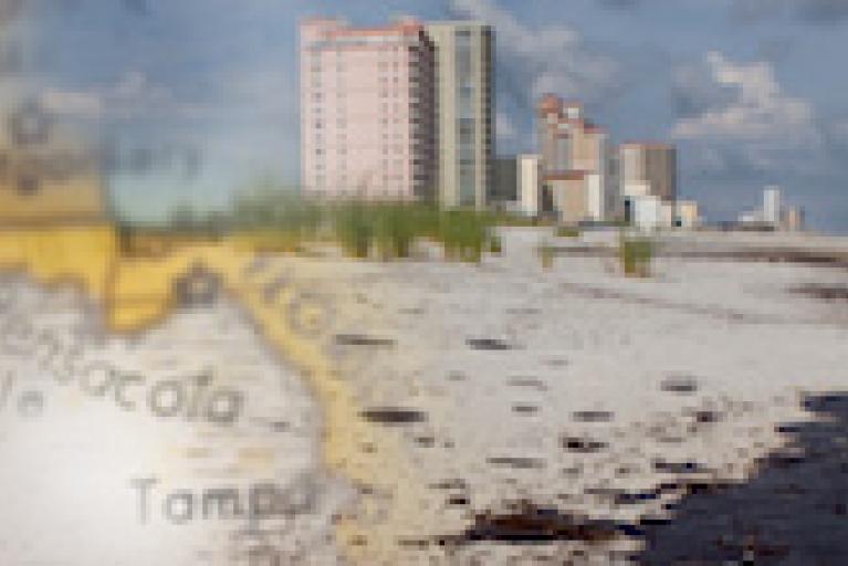 A blended image of a map and buildings along a beach that is polluted from an oil spill. 